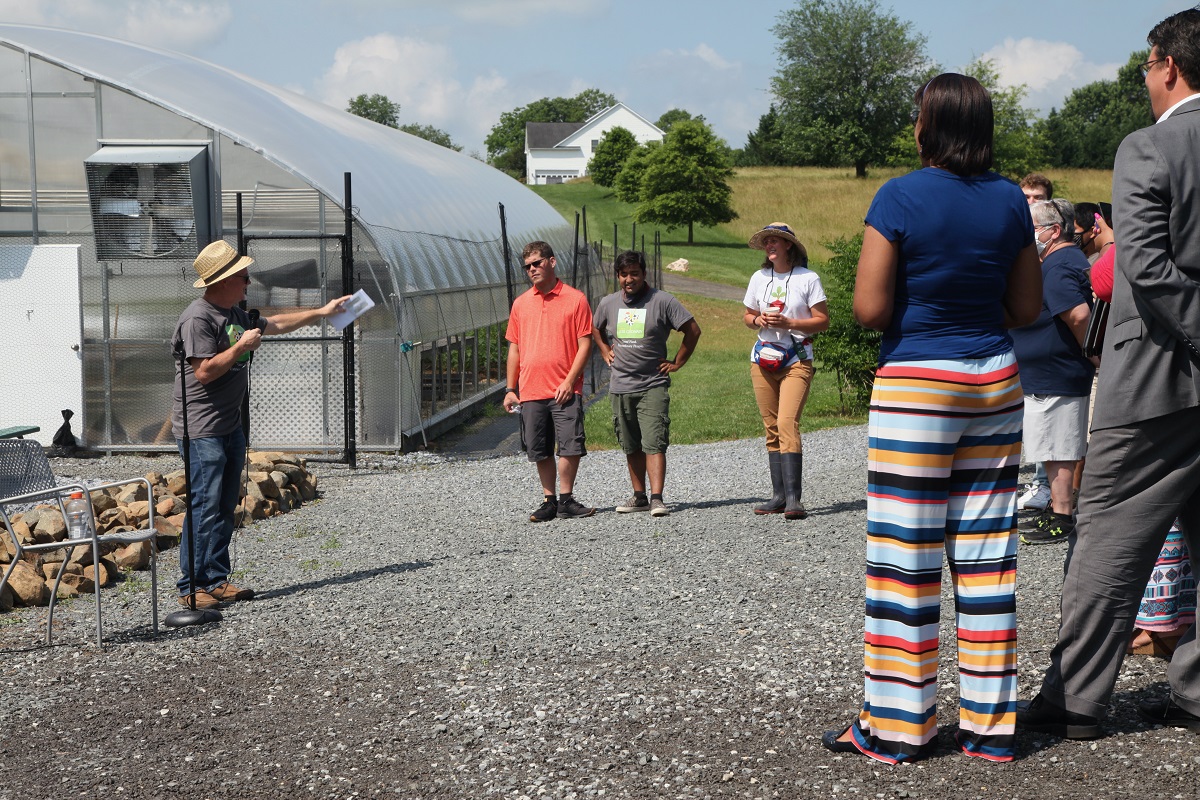 Greg speaking in front of the Greenhouse
