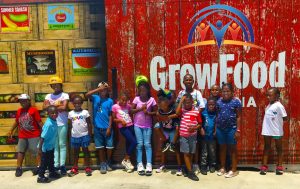 Kids in front of a "Grow Food" sign