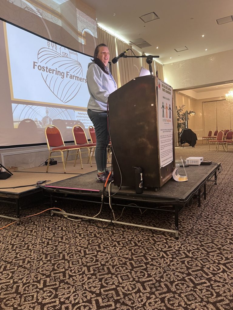 Kristin Hock, founder of Fostering Farmers, speaking to audience.