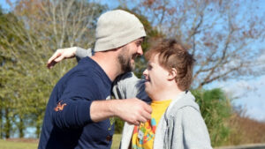 Two Peacehaven community members hug.