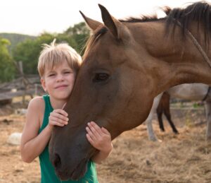 The Fox Moon Project- boy hugging horse